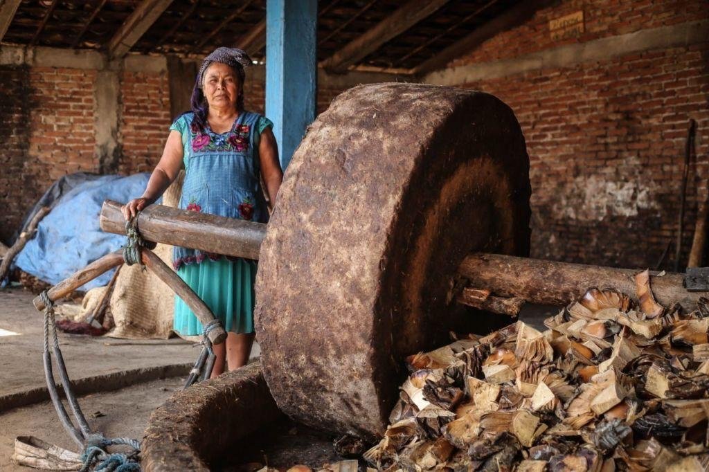 An artisan working beside a traditional tahona